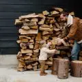 Man showing wood to little girl