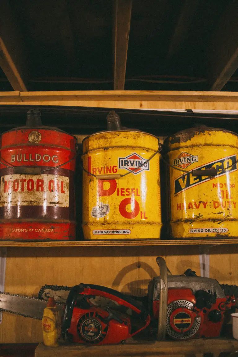 Oil cans and chainsaws on shelf
